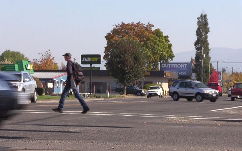 A man crosses Main Street: the project will improve safety for all travellers.