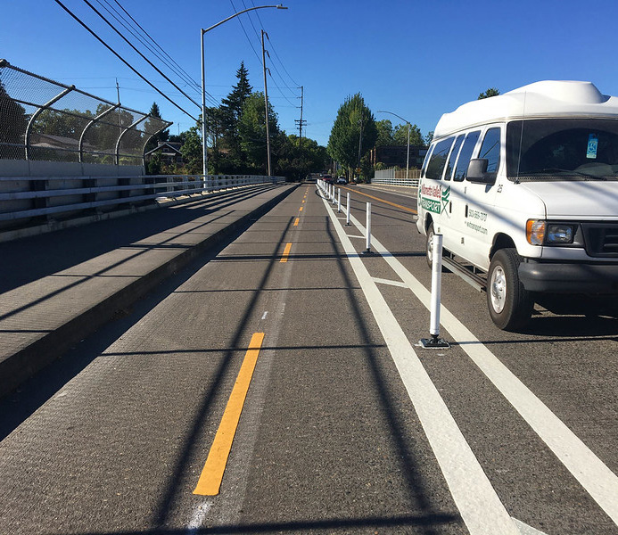 Image of a street with a protected bike lane.