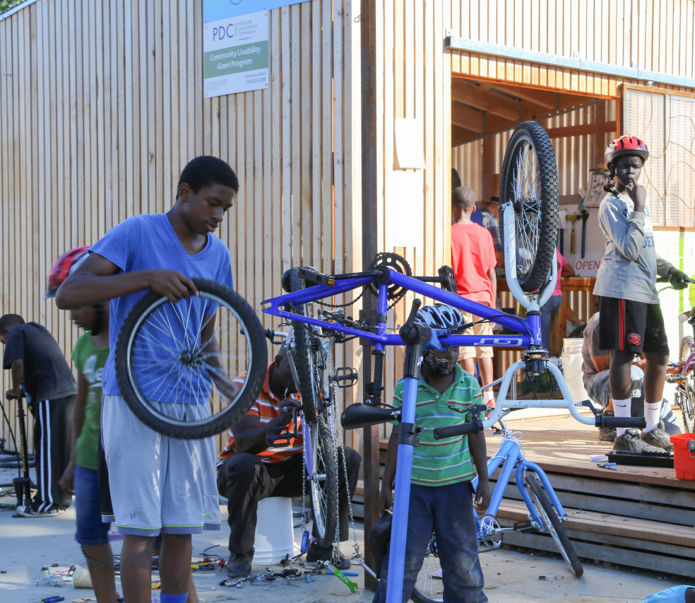 Image of people fixing bikes.