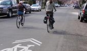 Image of people biking in a neighborhood greenway. - 