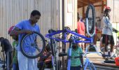 Image of people fixing bikes. - 