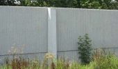 Existing Sound Wall - New sound walls will be similiar in size and appearance to the existing sound wall to the east. The ends of the walls would be secured with fencing to limit access between the wall and private fences.